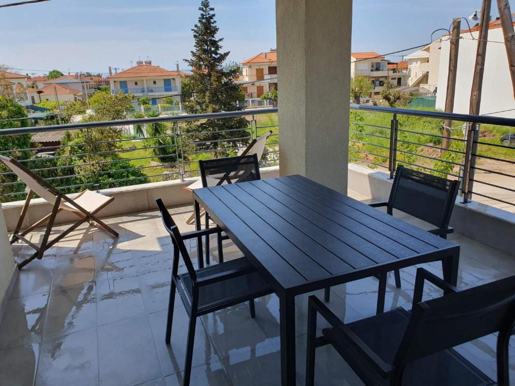 a table and chairs on a balcony with a view at Villa Modern Nikiti in Nikiti