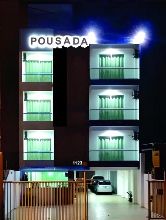a building with a car parked in front of it at Pousada Aliança in Salvador