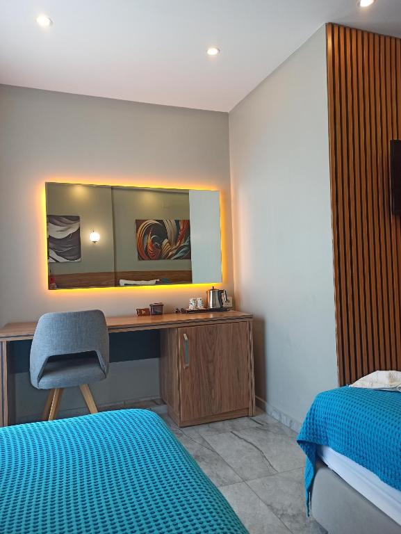 a bedroom with a desk and a bed and a chair at Başar hotel in Erdemli