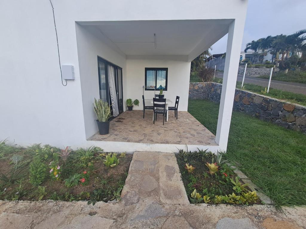 a patio of a house with a table and chairs at Evasion Maragon in Saint Gabriel