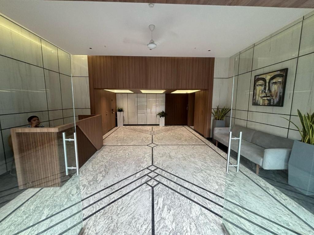 a lobby of a building with a glass floor at Greenland Apartment in Pune