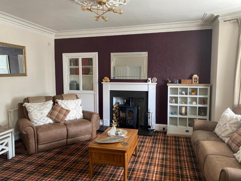 a living room with two couches and a coffee table at Clune House B&B in Newtonmore