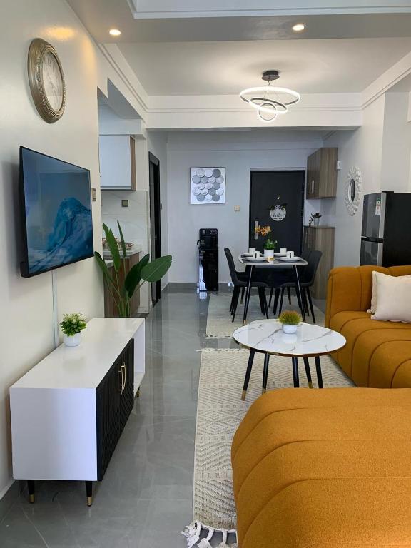 a living room with a couch and a table at Amari Suites in Gatunga