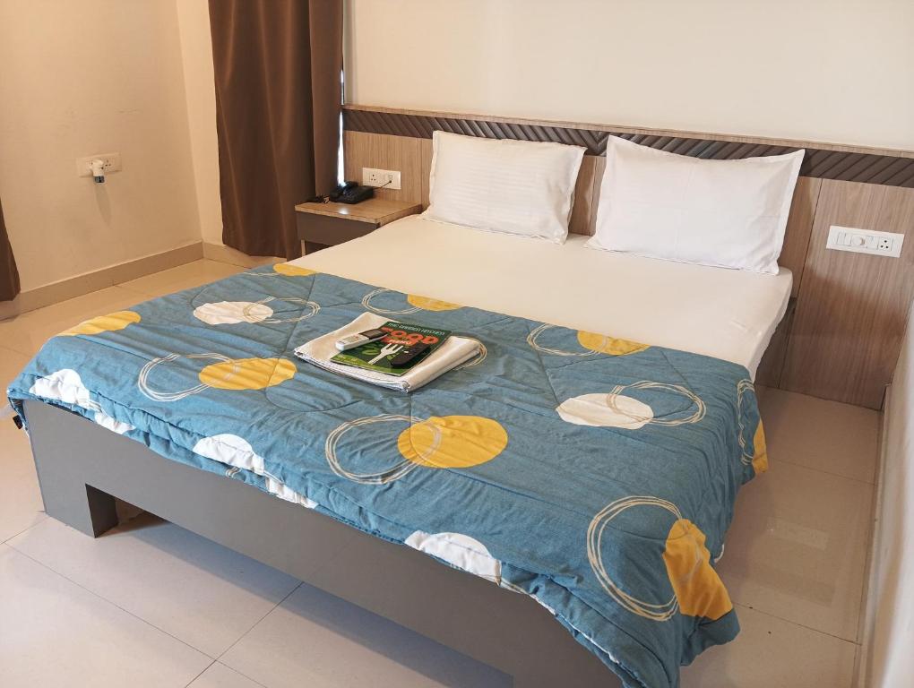 a hotel room with a bed with a book on it at Embassy Suites in Hyderabad