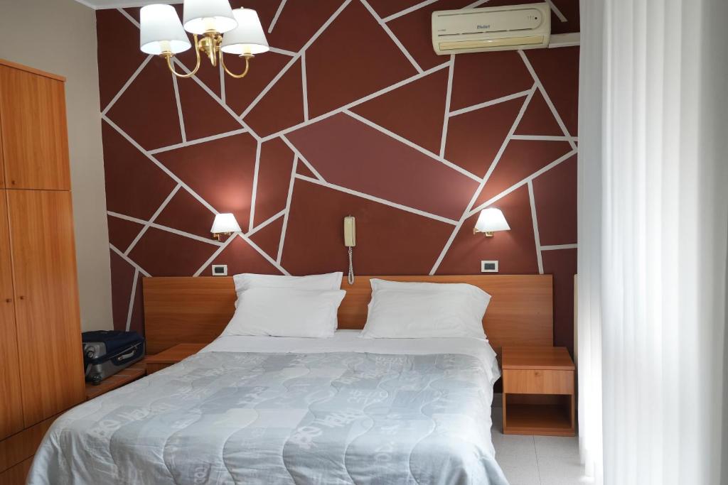 Postel nebo postele na pokoji v ubytování Hotel Marconi