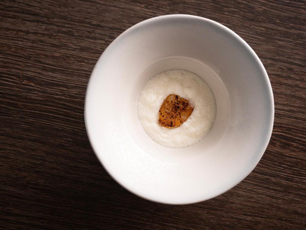 a doughnut in a white bowl on a table at Hotel Arctic in Ilulissat