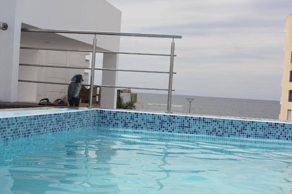 a person is standing next to a swimming pool at 2br 1ba Condo 1 block to ocean Condo 1 in Mazatlán