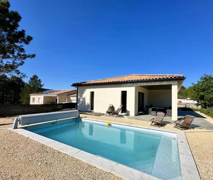 a swimming pool in front of a house at Villa Dyane in Salavas