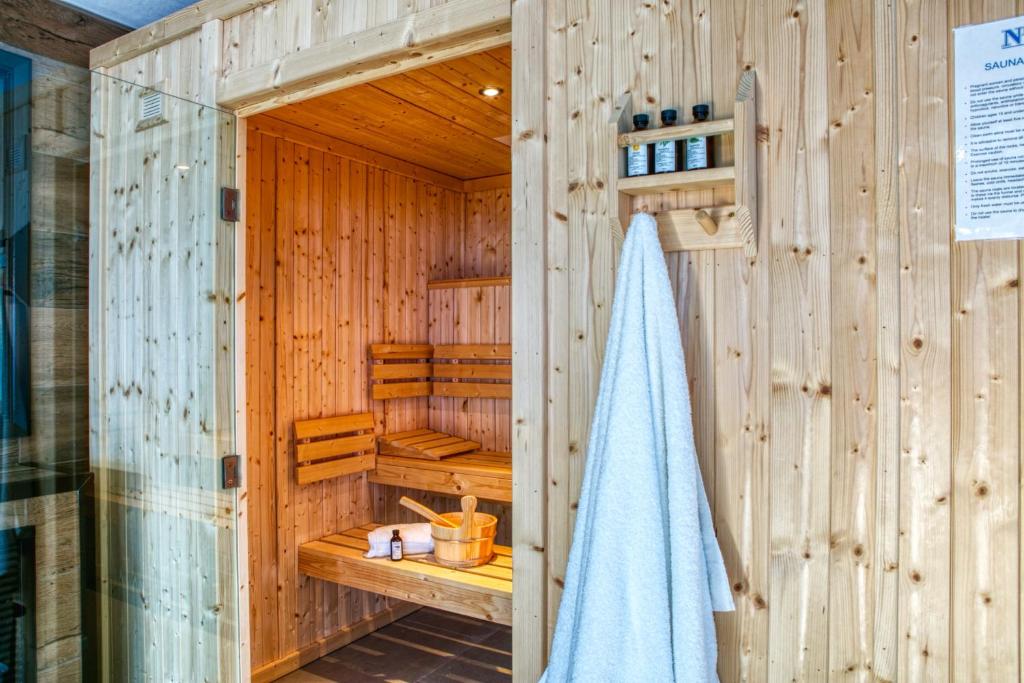 a bathroom with a shower with a towel in it at Newlands Holidays in Bridport