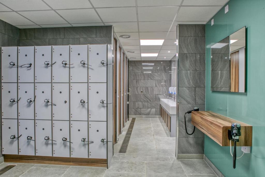 a locker room with lockers and a sink at Newlands Holidays in Bridport