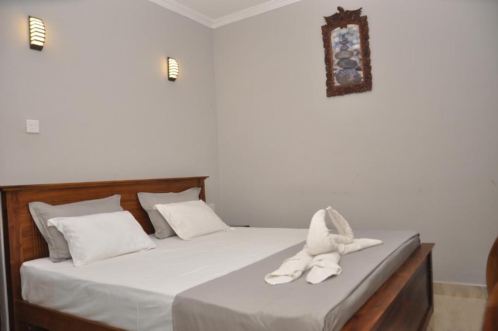 Postel nebo postele na pokoji v ubytování Golden Shower Inn