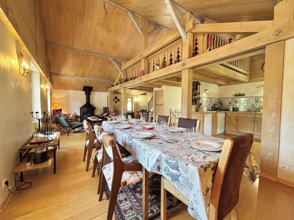 une grande salle à manger avec une longue table et des chaises dans l'établissement Appartement de 5 pièces à Praz-sur-Arly avec cheminée, mezzanine et parking - 8 pers - FR-1-603-7, à Praz-sur-Arly
