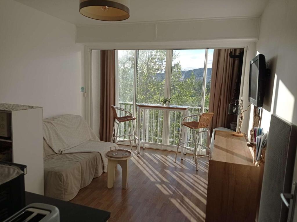 d'un salon avec un canapé et un balcon. dans l'établissement Studio Accès Plage avec Parking et Ascenseur - FR-1-308-207, au Lavandou