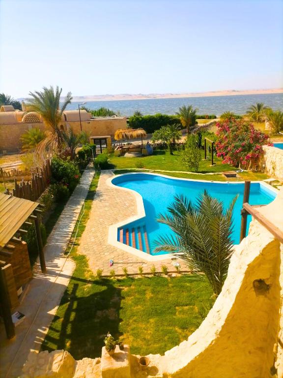 an overhead view of a swimming pool at a resort at Tunis Village,lake view countryside villas in Tunis