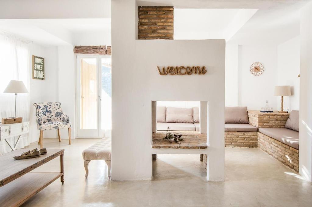 a living room with a fireplace and a couch at Terramare Villa's 4 in Kithnos
