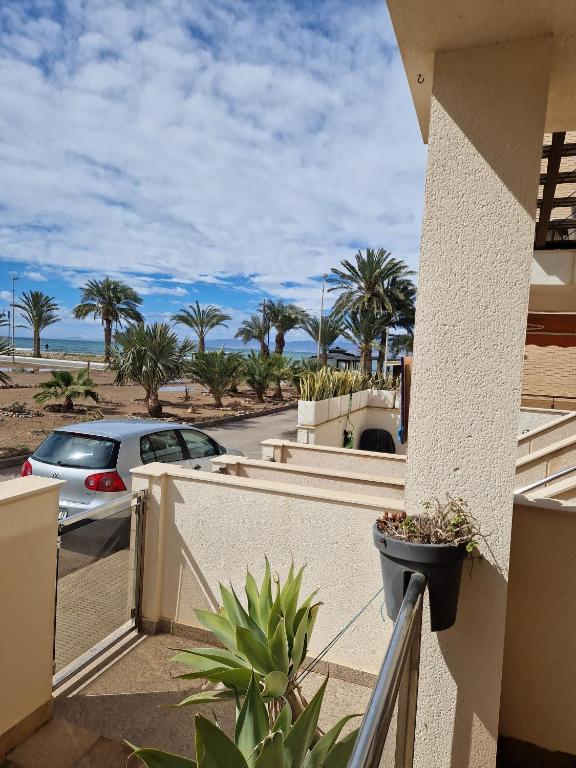 a balcony with a view of the ocean and palm trees at Casa Krystyna La Azohia in Cartagena