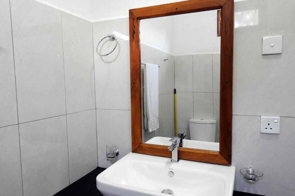 Koupelna v ubytování Coral Waves Inn Pasikuda