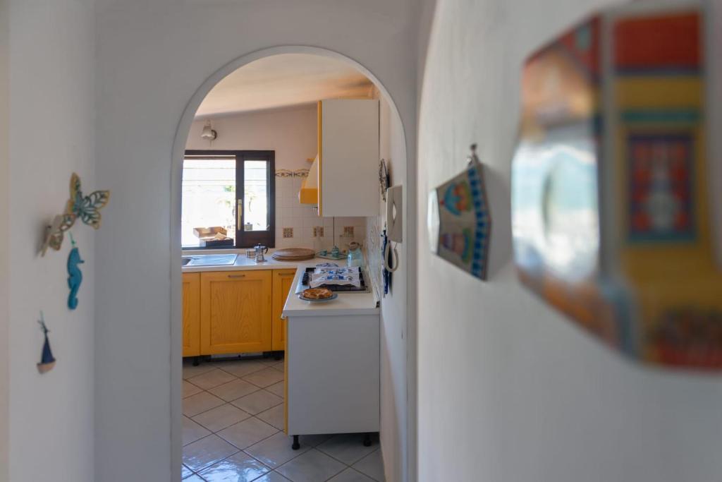 an archway in a kitchen with a white refrigerator at Mare Amore Fantasia in Gaeta