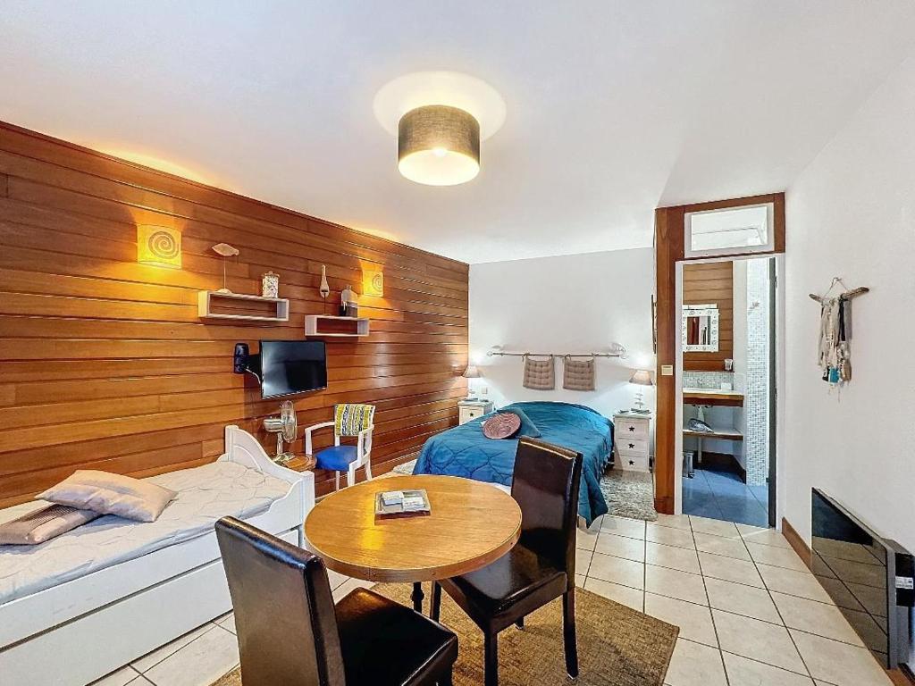 a bedroom with a bed and a table in a room at Casanella in Le Hézo
