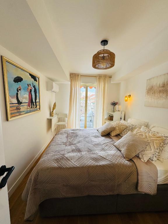 une chambre avec un grand lit et une fenêtre dans l'établissement Residence Butterfly, à Nice