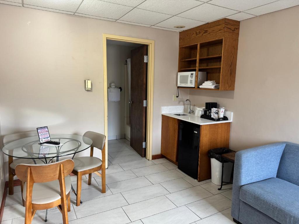 a kitchen and a dining room with a table and a couch at South Shore Inn in Sandusky