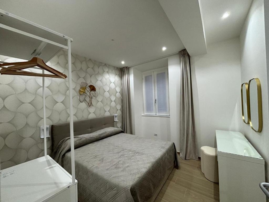 a small bedroom with a bed and a sink at Bella Como Holiday Apartment in Como