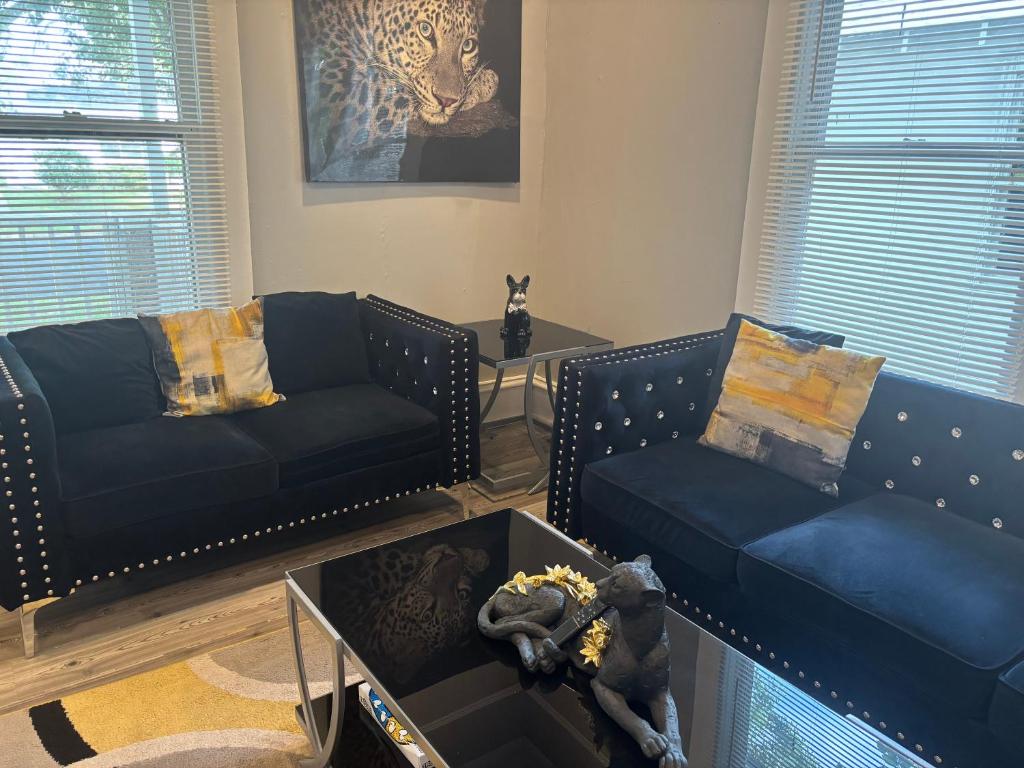 a living room with two blue couches and a table at Nice & Cozy 3 bedroom Escape in Waycross