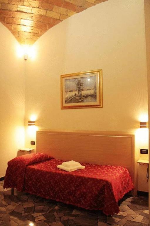 Postel nebo postele na pokoji v ubytování Hotel Campidoglio