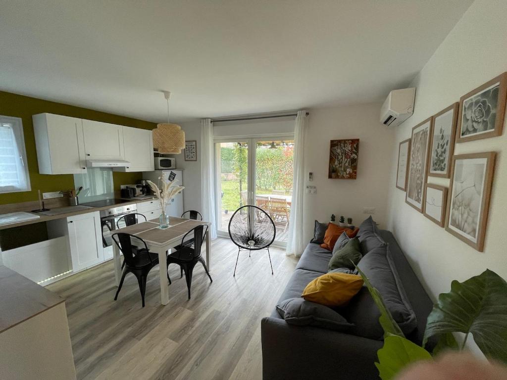 un salon et une cuisine avec un canapé et une table dans l'établissement Ty Green, à Montboucher-sur-Jabron