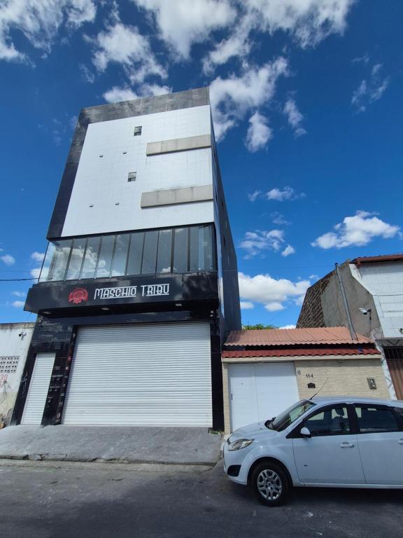 a white car parked in front of a building at Condomínio Tribu 02 in Caruaru