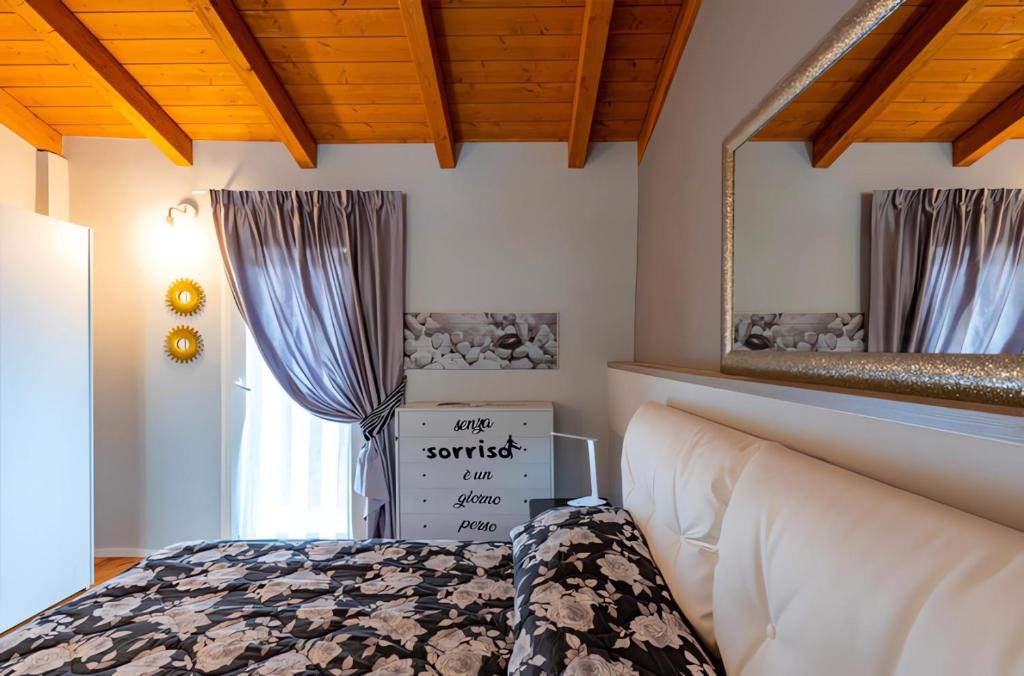 a bedroom with a bed and a mirror at Antico Borgo Monregale in Mondovì