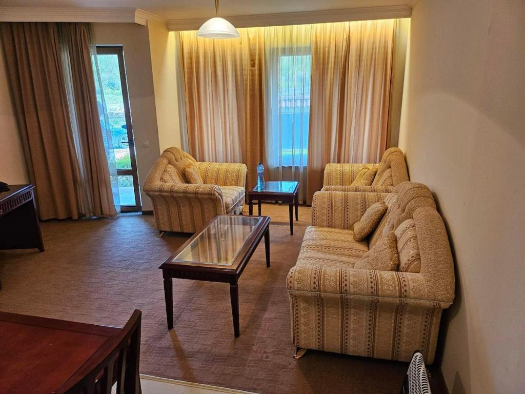 a living room with two couches and a coffee table at Luxury apartment in Downtown Resort Bansko in Bansko