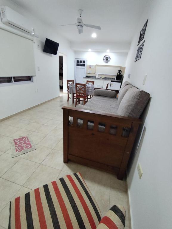 a living room with a bed and a kitchen at B&Z Departamentos in Federación
