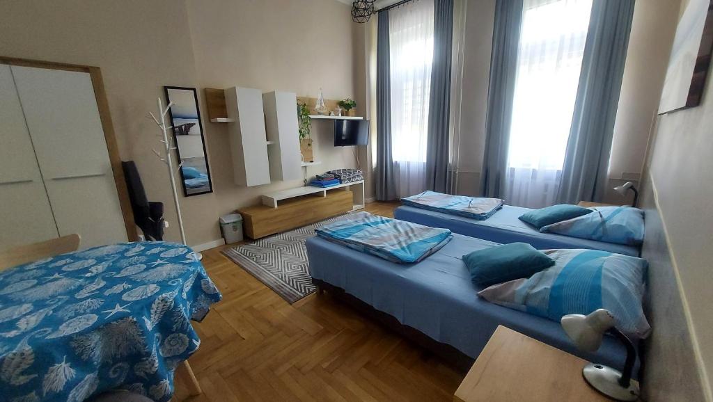 a bedroom with two beds and a mirror at Wanta 2 Kołobrzeg in Kołobrzeg