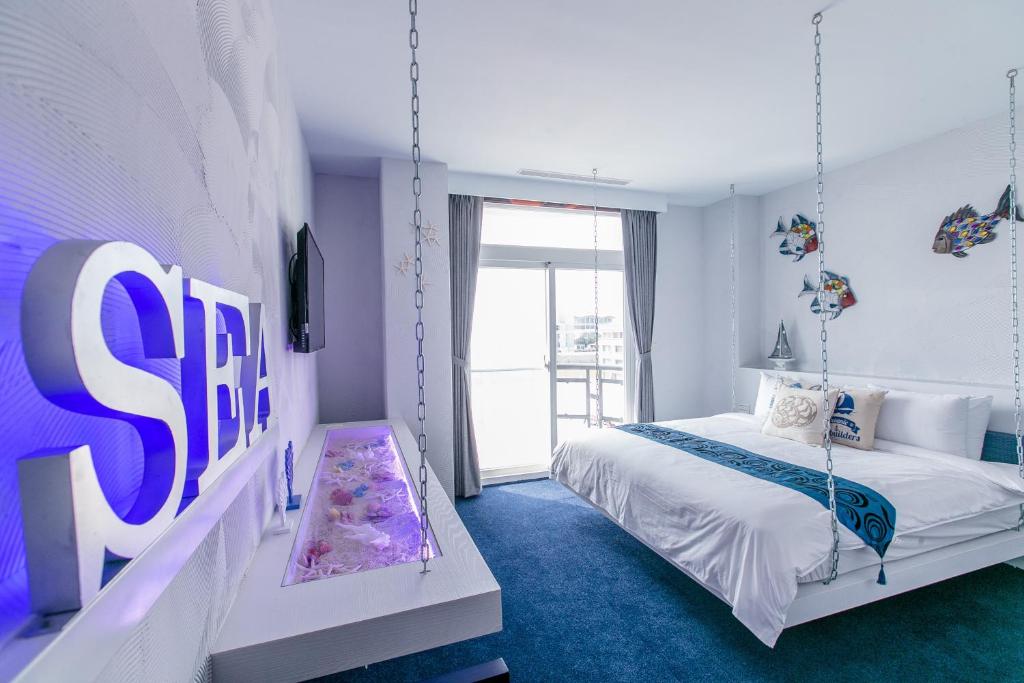 Postel nebo postele na pokoji v ubytování Jin Pin Hotel