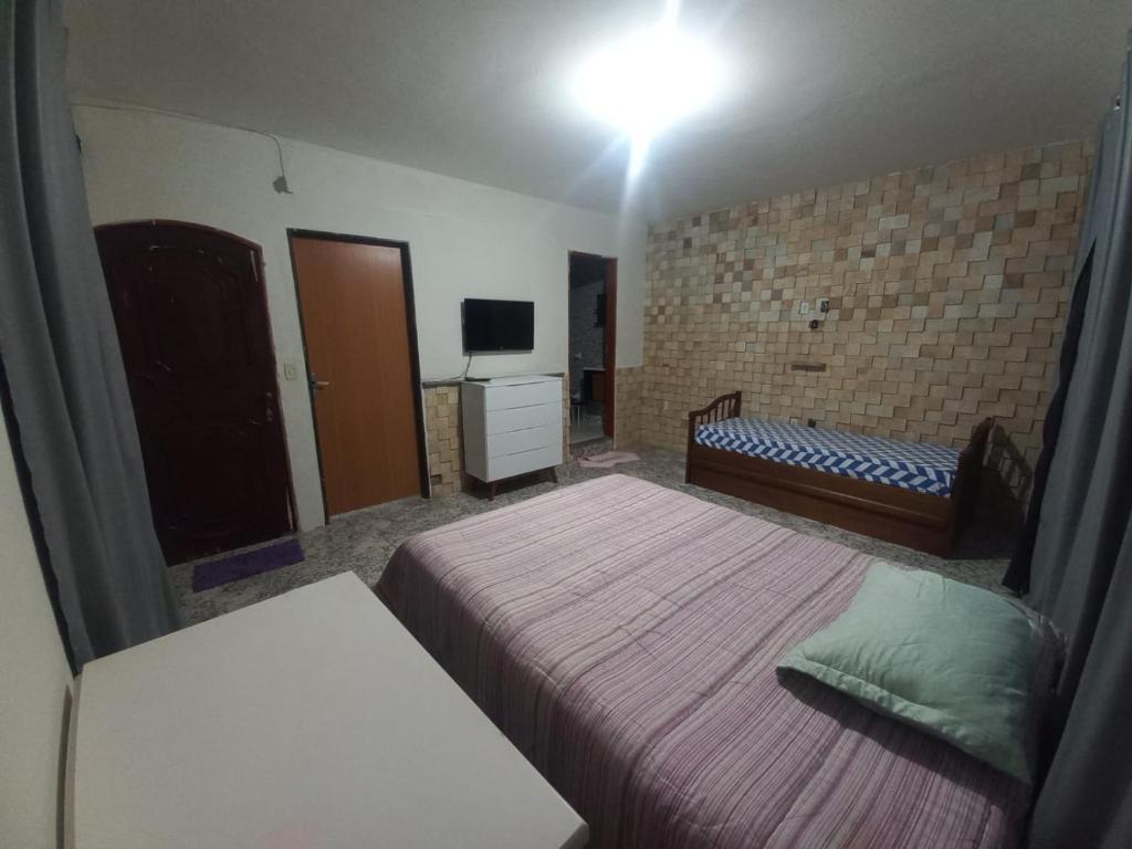 Postel nebo postele na pokoji v ubytování Suíte Bob Marley