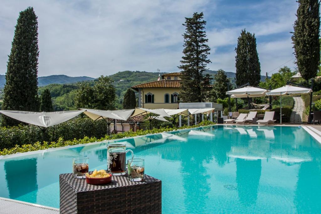 a pool at a villa with a resort at Villa Parri Residenza D'epoca in Pistoia