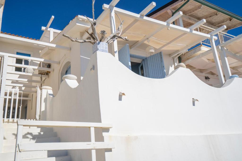 a white house with a slide in front of it at I Gradini sul Mare in Santa Maria