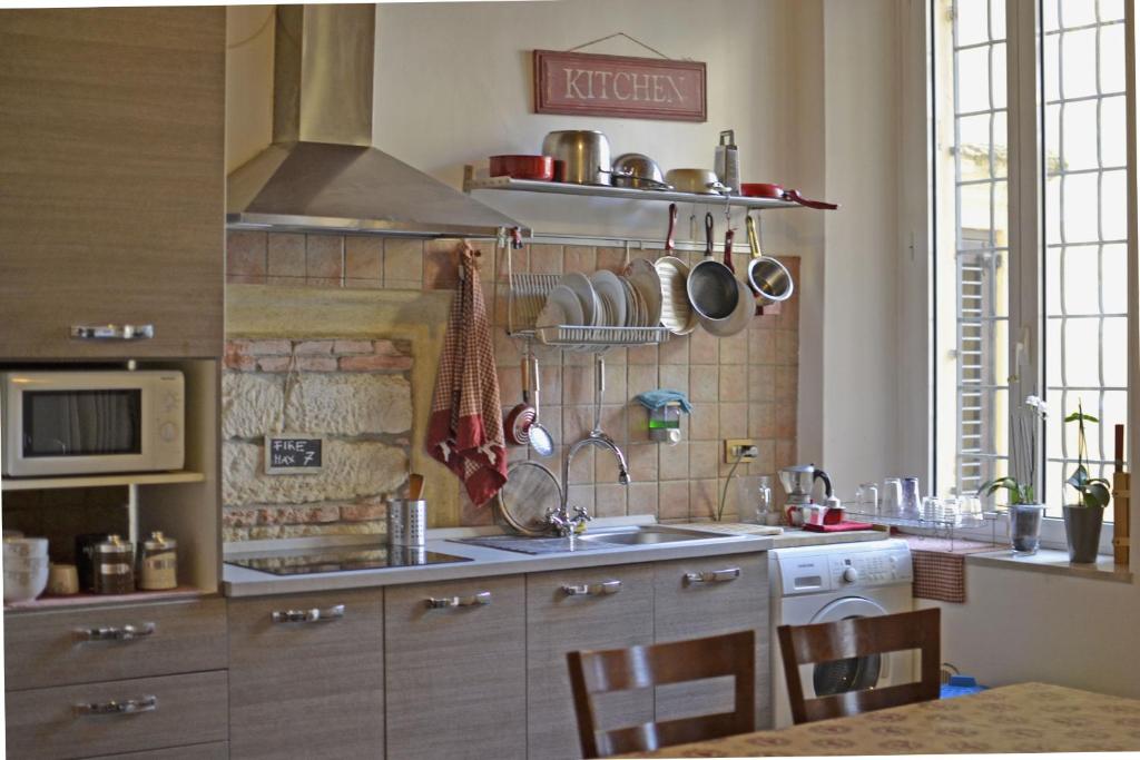 a kitchen with a sink and a stove top oven at Ai Leoni in Verona