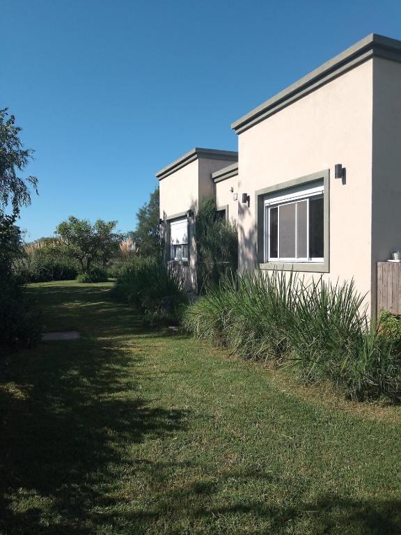 a house with a yard next to a building at Bello atardecer Uribe in Uribelarrea