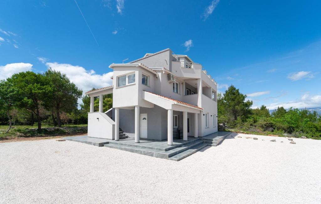 a large white house on a gravel lot at Awesome Apartment In Pridraga With Wifi in Pridraga