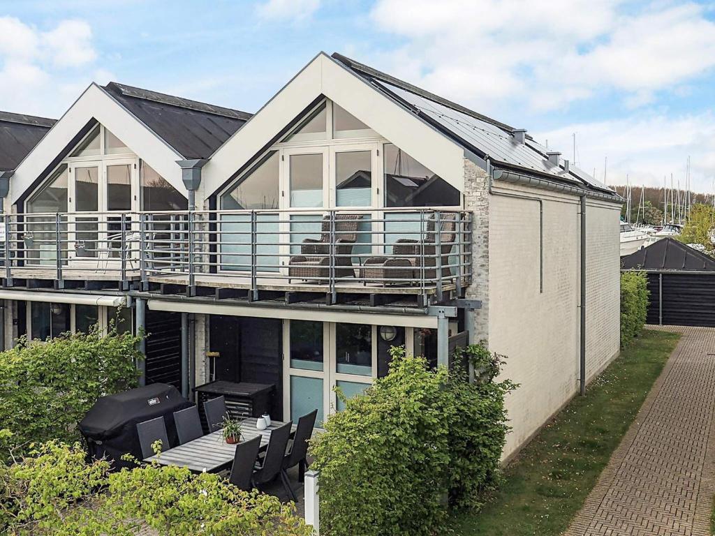 a large house with a balcony and some chairs at 5 star holiday home in Køge in Køge