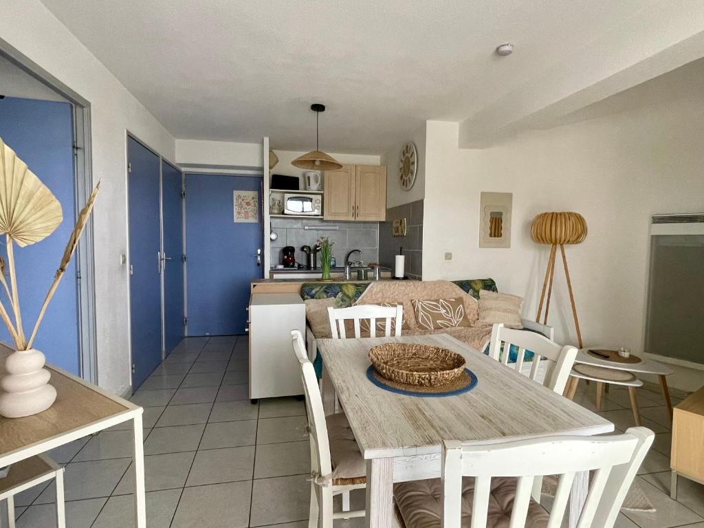 une cuisine et un salon avec une table et des chaises dans l'établissement Appartement 3 pièces avec piscine proche de la plage - FR-1-748-31, à Canet