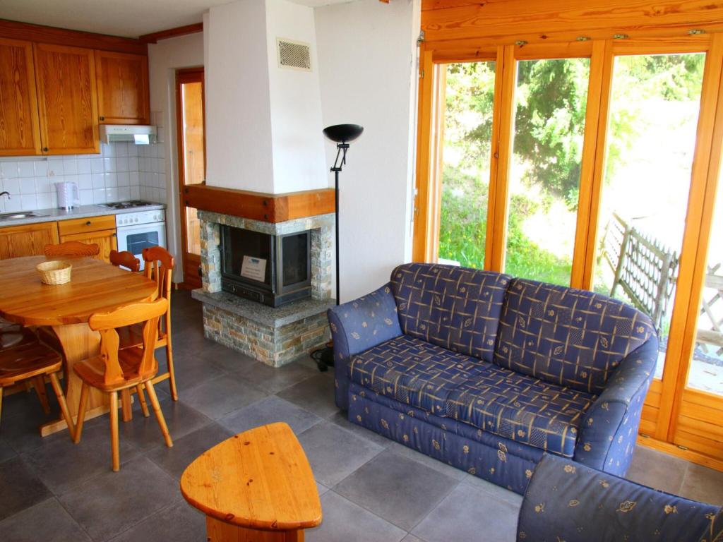 a living room with a couch and a table at Alluring apartment in Les Agettes in Agettes
