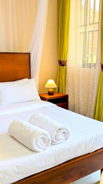 Postel nebo postele na pokoji v ubytování Ahva III Residence