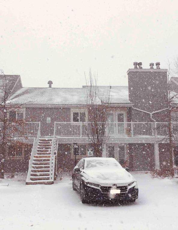 a car parked in front of a house in the snow at New Management - Collingwood Getaway in Collingwood