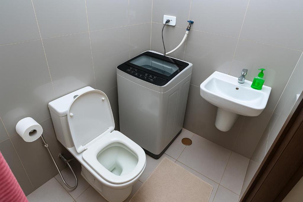 a bathroom with a toilet and a sink at SkyVista Luxe Makati Staycation Pool Gym Netflix 5637 in Manila