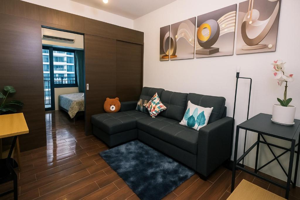 a living room with a couch and a table at The Giggle Spot Cozy Makati Hideaway Pool & Gym 2270 in Manila