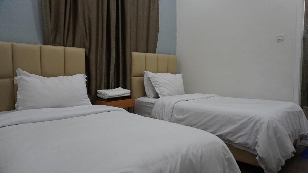 Postel nebo postele na pokoji v ubytování Diyar Villas Puncak F4/8