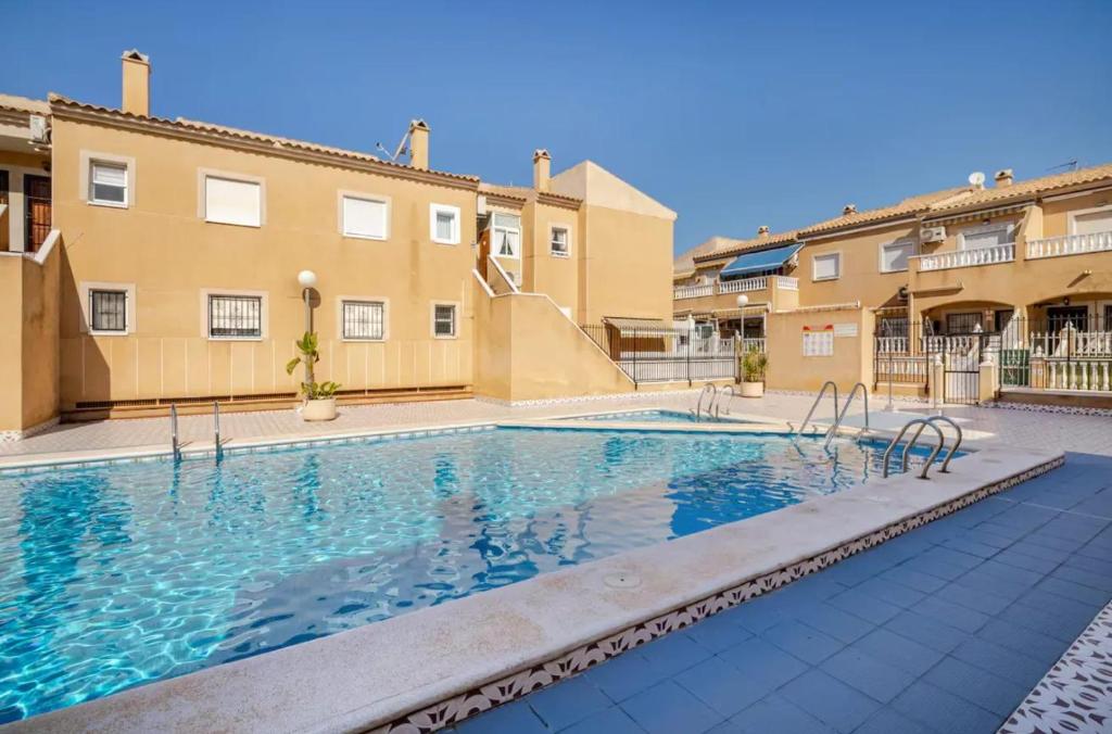 a swimming pool in the middle of a building at Charming Studio in Torrevieja, 75 sqm with Shared Pool in Torrevieja